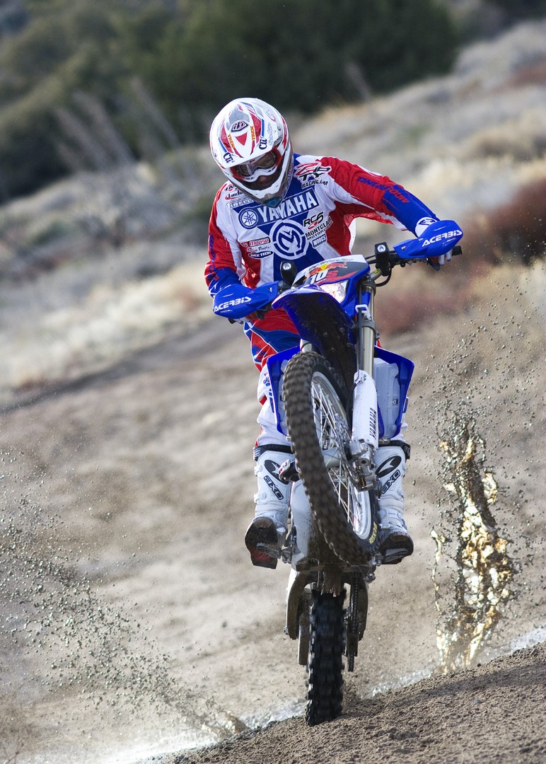 Photograph of one person riding a motorbike