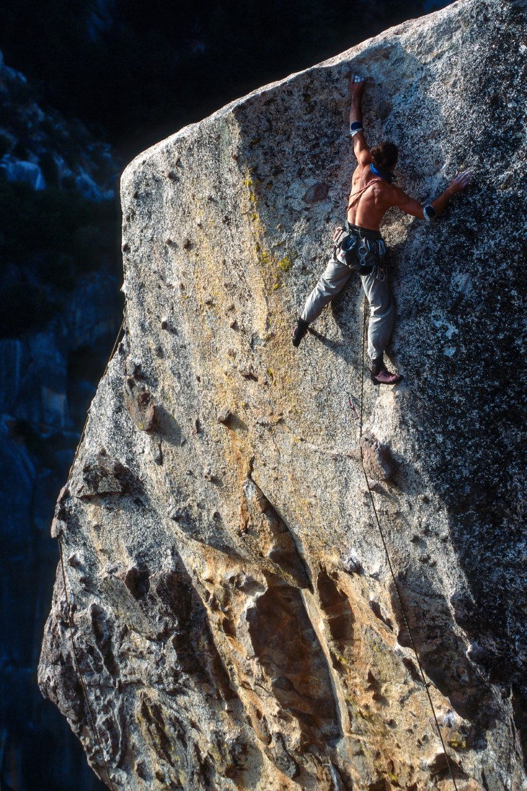 Photograph of one person climbing a mountain