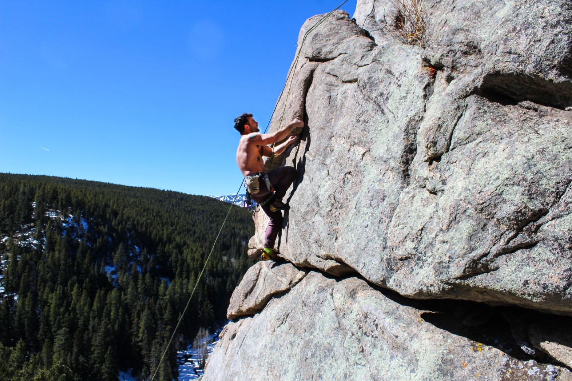 Photograph of one person climbing a mountain