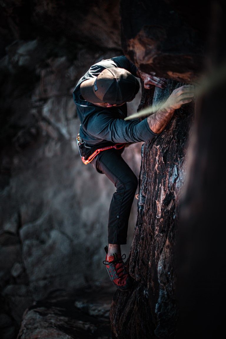 Photograph of one person climbing a mountain